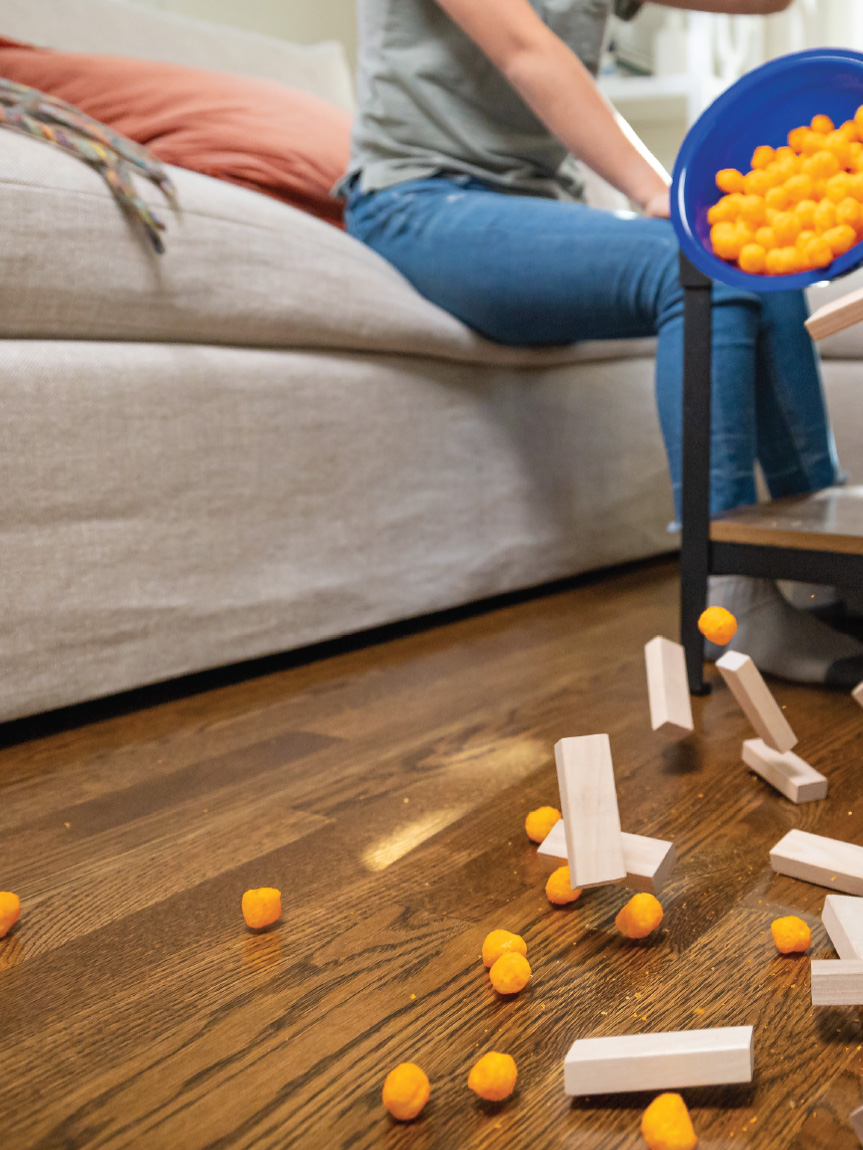 Mom and daughter playing with tablet on hard surface floor