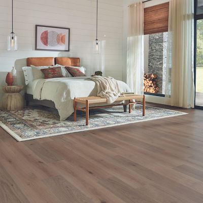 wood look laminate flooring in a cozy rustic bedroom